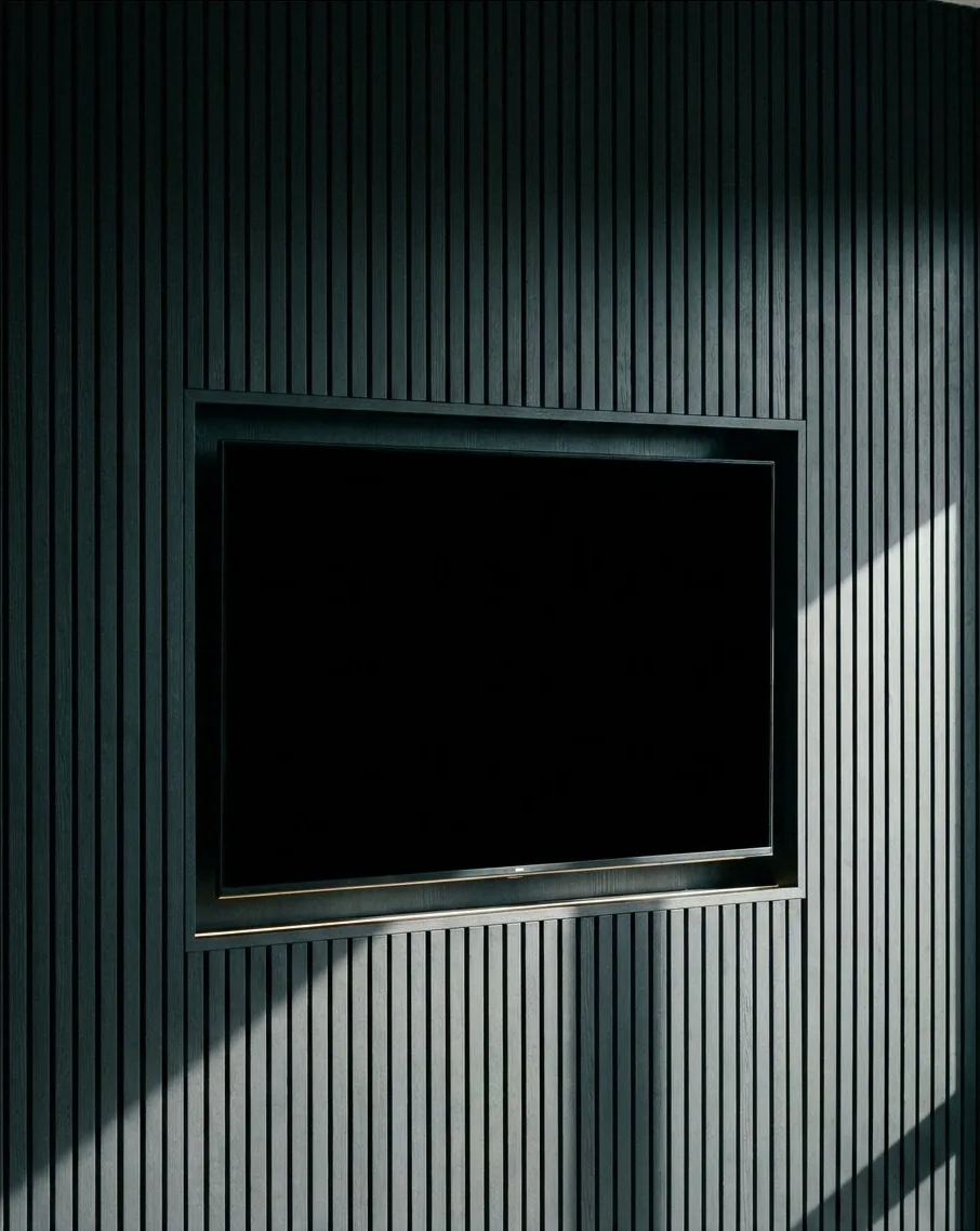 Feature media wall with slatted panelling and textured finish